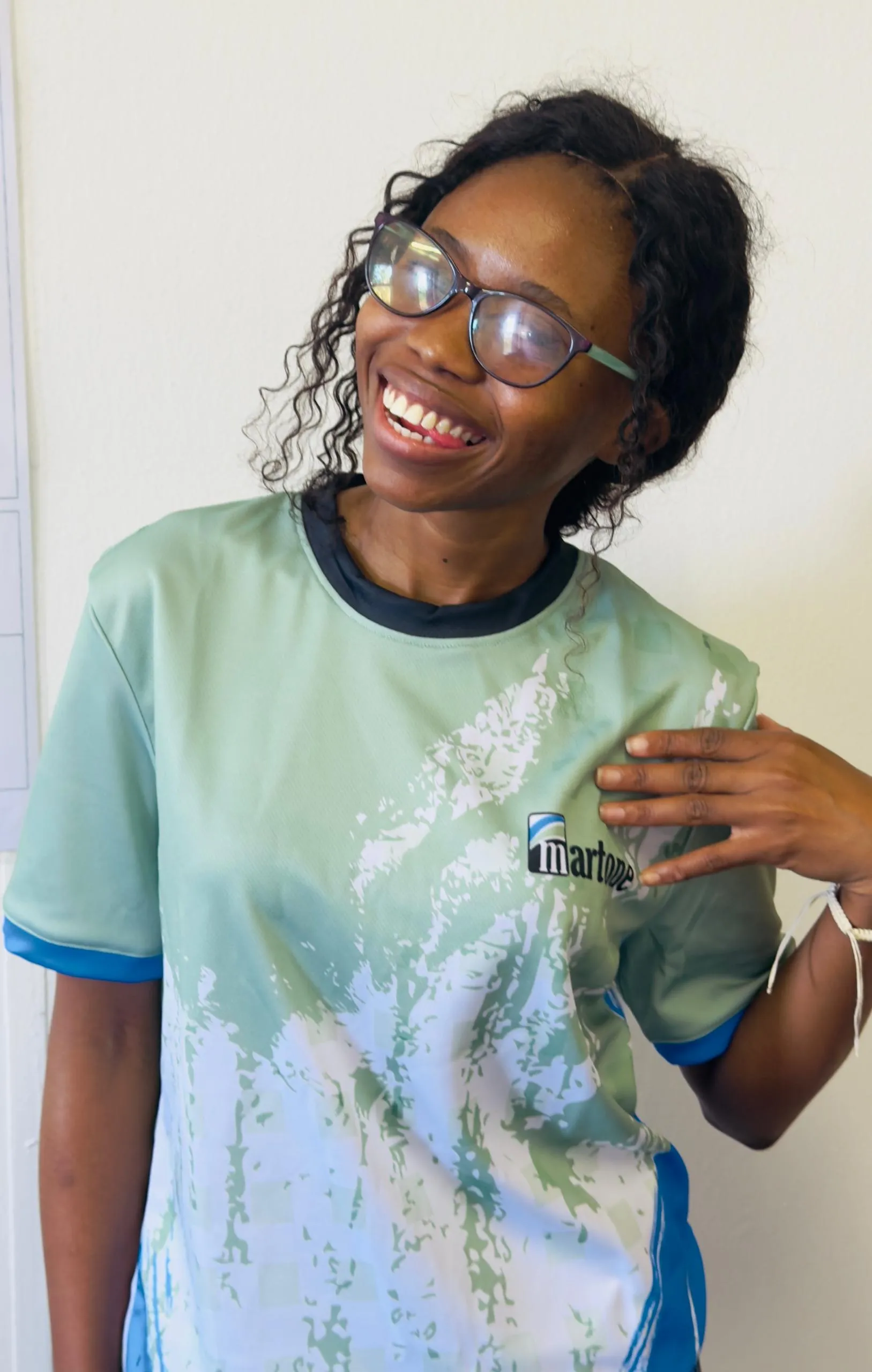 Martone Planning Studio team member smiling, wearing a Martone-branded shirt