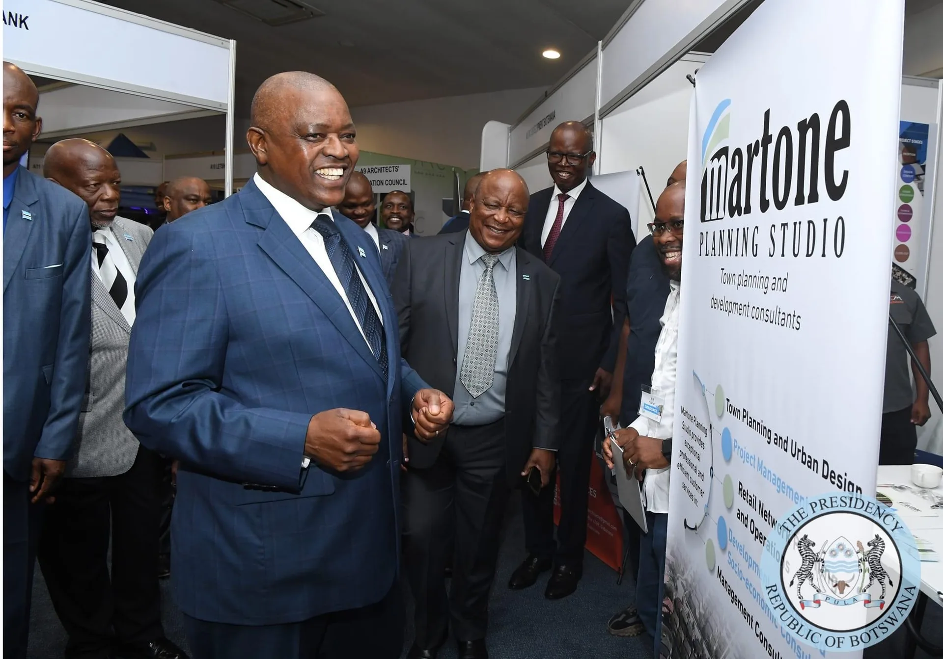 Martone Planning Studio exhibition banner at the Housing Pitso, with officials in attendance
